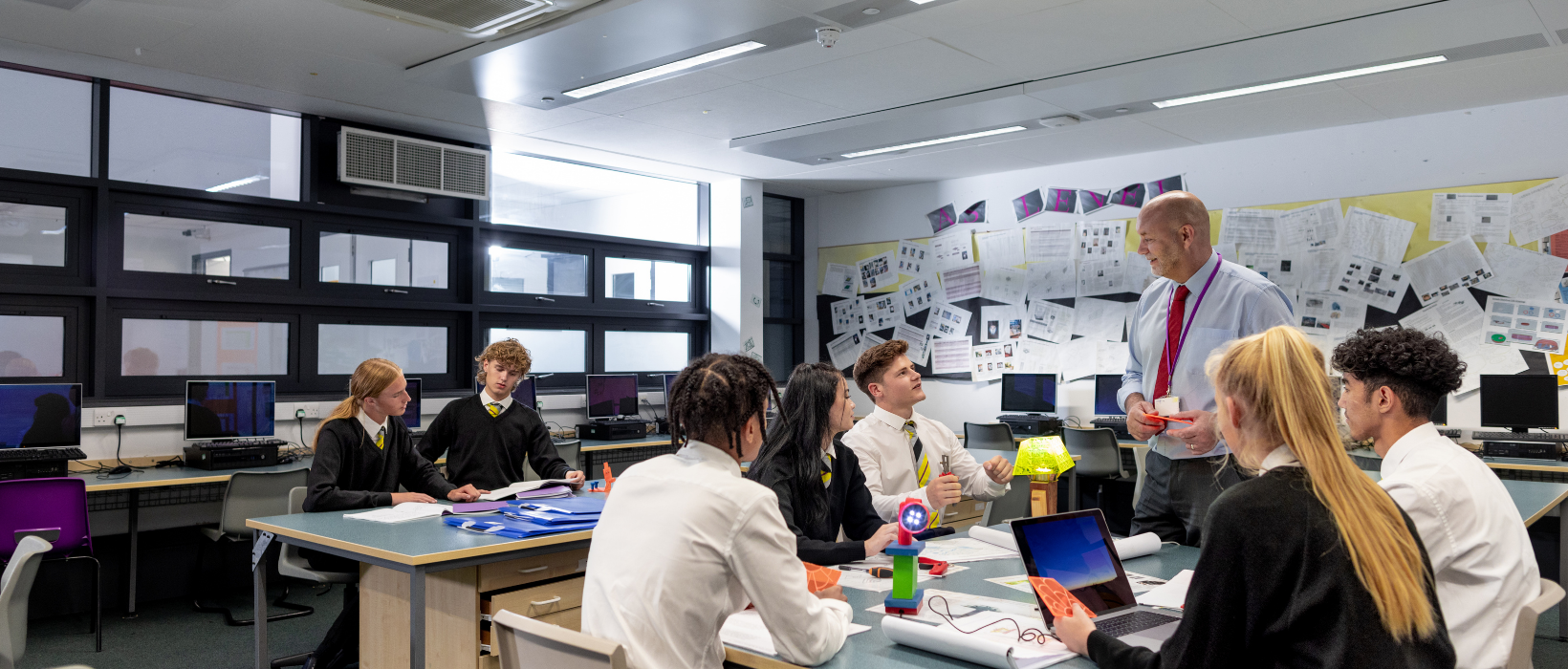 Secondary school students talking with their teacher